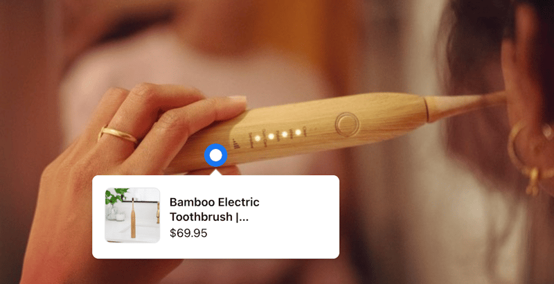 A women brushes her teeth with Sustainable Tomorrows toothbrush. A linked product tag floats overtop.