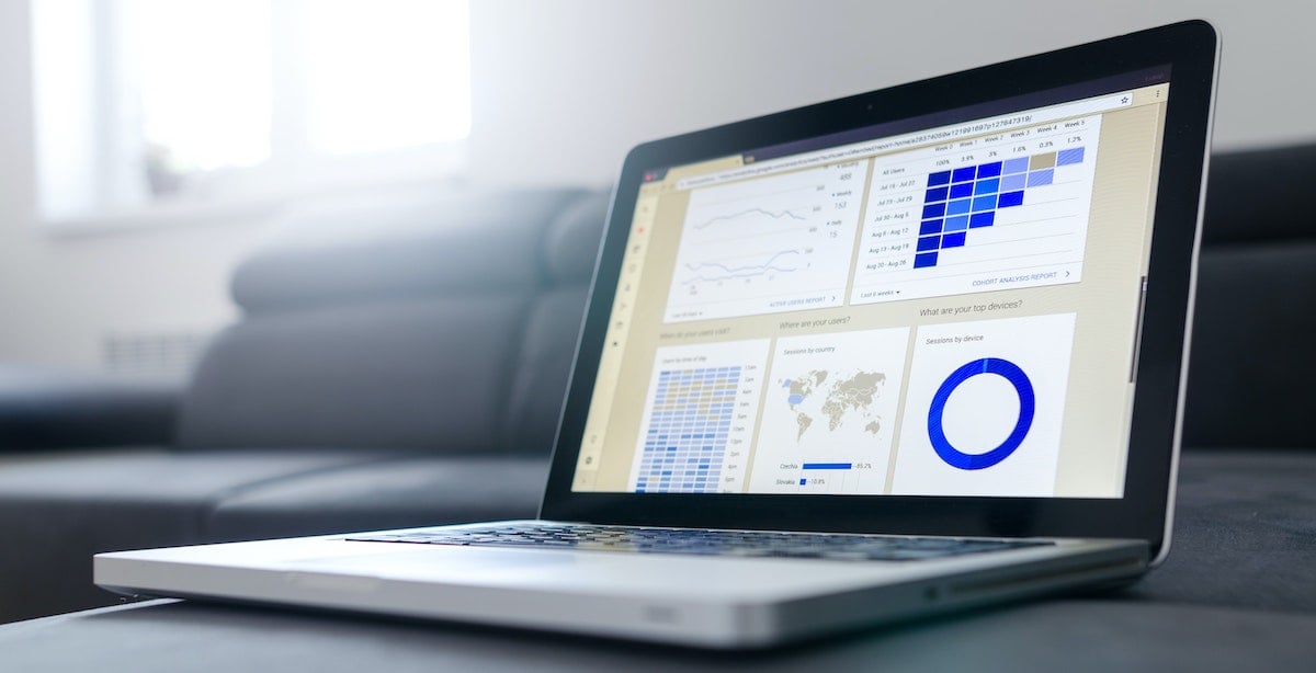 MacbookPro with an insights and data dashboard displaying results on the screen.