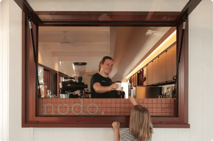 Nodo employee serving a customer