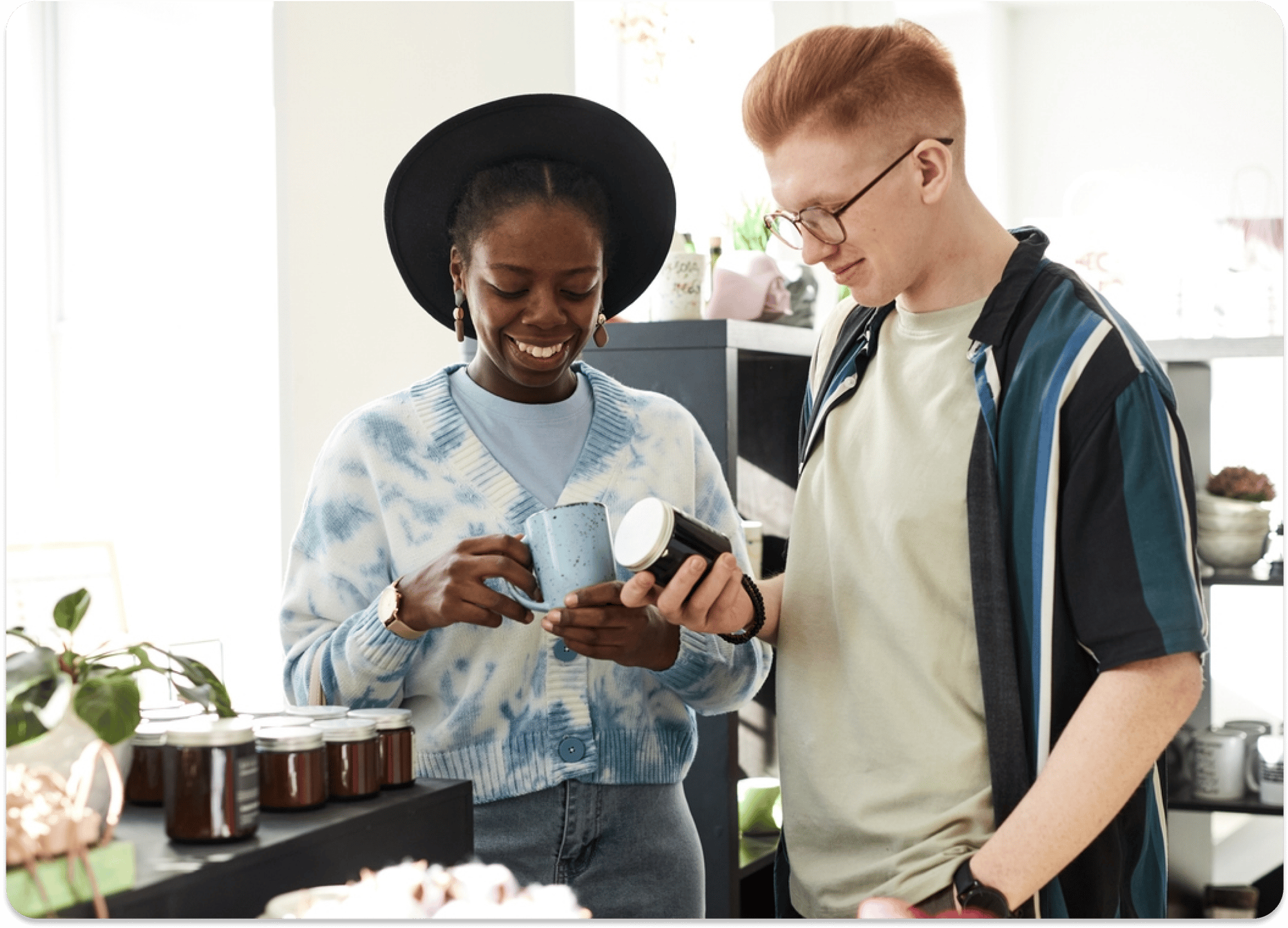 Smiling couple shopping for mugs in a store