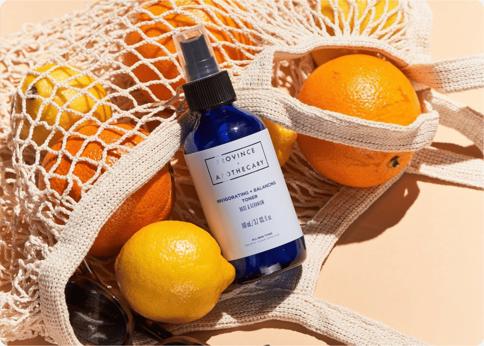 Province Apothecary Serum placed on top of oranges