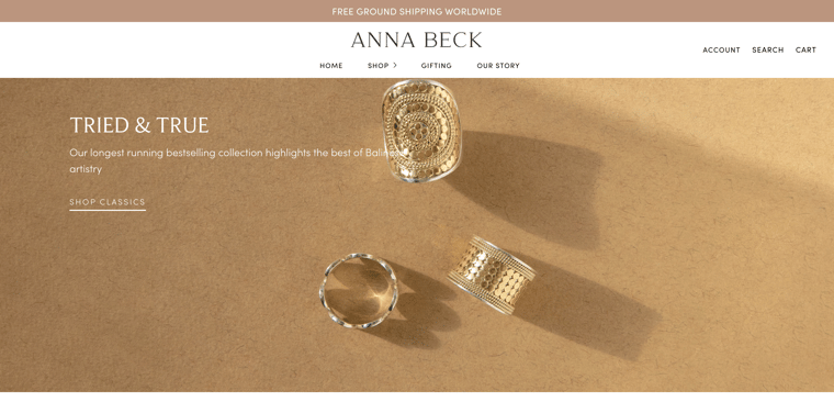 Anna Beck's online store with three ornate gold rings featured in a full-width product photo under the fold.